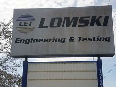 This is Lomski business sign before pressure washing